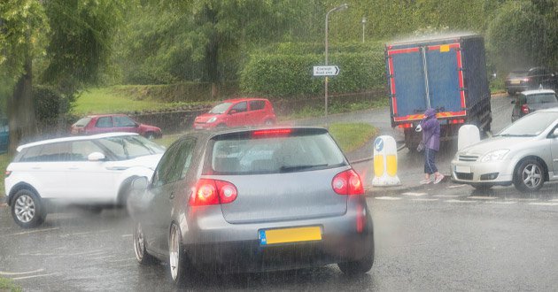 Heavy rain, day, junction traffic.